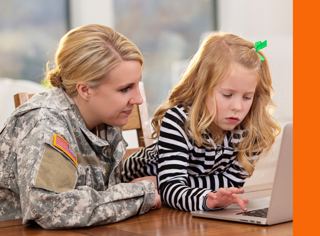 A woman in military uniform and a young girl are focused on a laptop screen together, sharing a moment of connection.